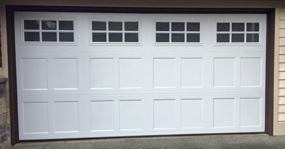 A Closed White Garage Door with a Glass Window