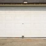 A white colored closed garage door installation in Kirkland