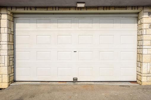 A white colored closed garage door installation in Kirkland